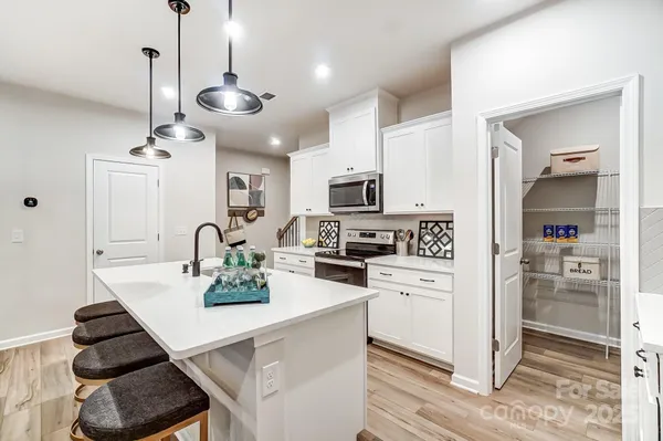 a kitchen with stainless steel appliances kitchen island granite countertop a sink and cabinets