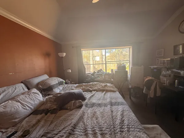 a bed sitting in a bedroom next to a window