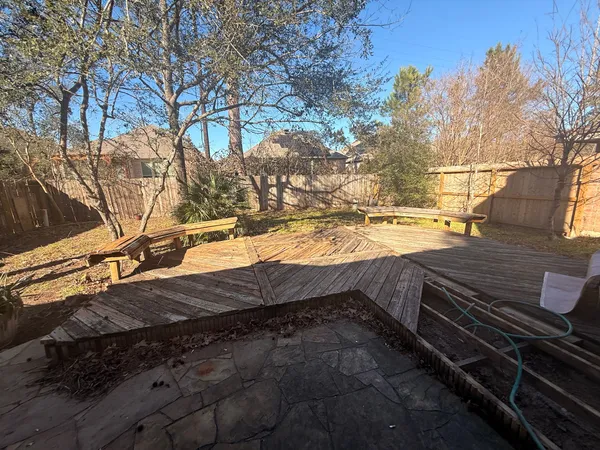 a view of a backyard with wooden fence