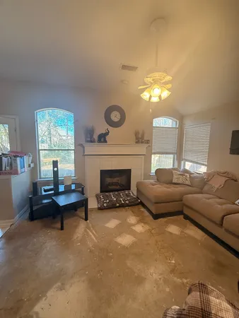 a living room with furniture and a fireplace