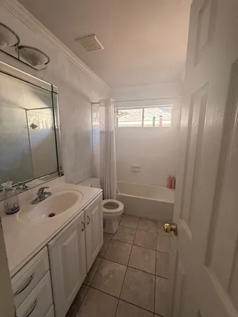 a bathroom with a double vanity sink toilet and shower