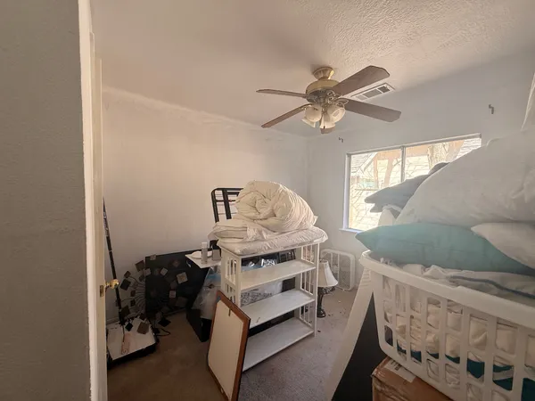 a bedroom with furniture and a window