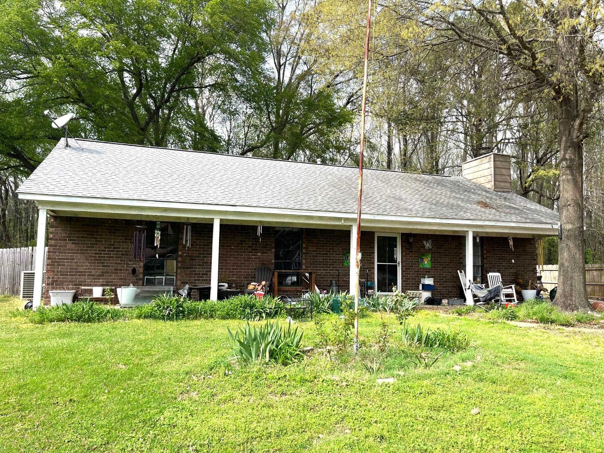 2467 Flowering Tree Drive Bartlett, TN 38134 - Photo 1 of 22 a front view of a house with garden and outdoor seating