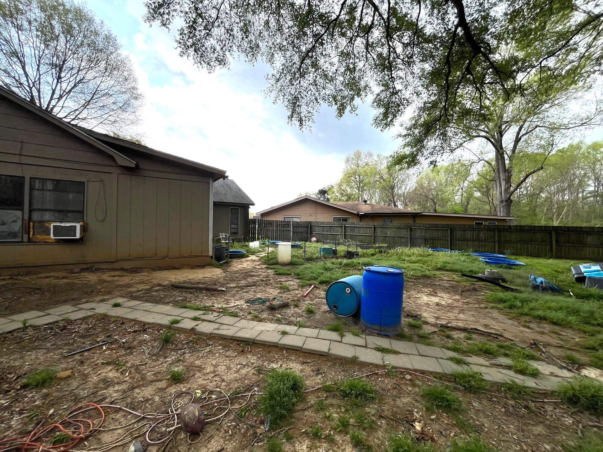 2467 Flowering Tree Drive Bartlett, TN 38134 - Photo 19 of 22 a backyard of a house with wooden fence and a fire pit