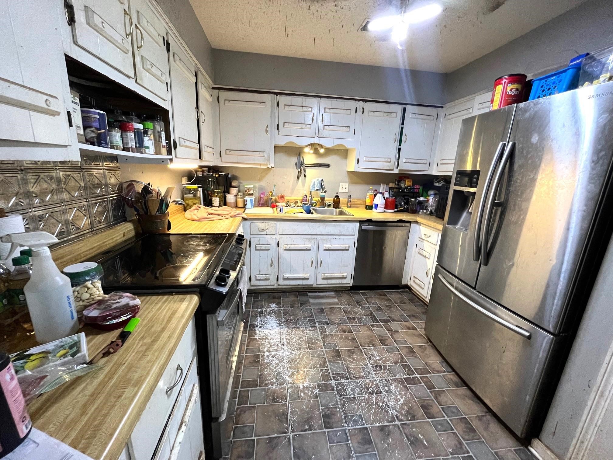 2467 Flowering Tree Drive Bartlett, TN 38134 - Photo 7 of 22 a kitchen with stainless steel appliances a stove a refrigerator and a refrigerator
