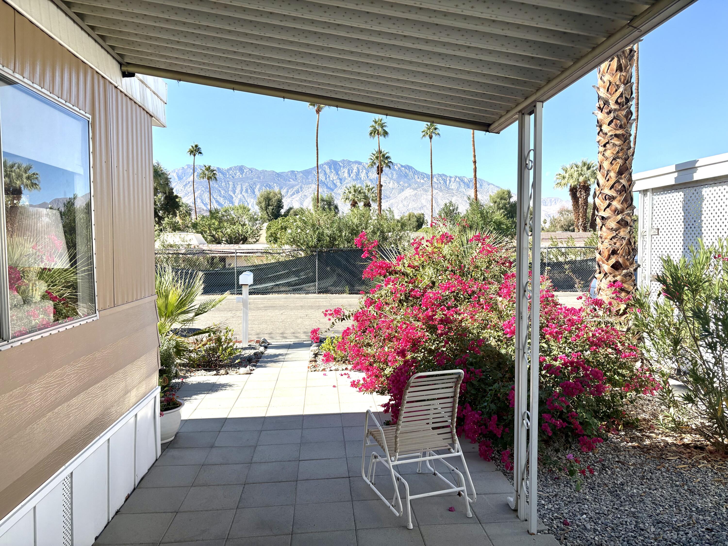a view of a porch with dining table and chairs and potted plants