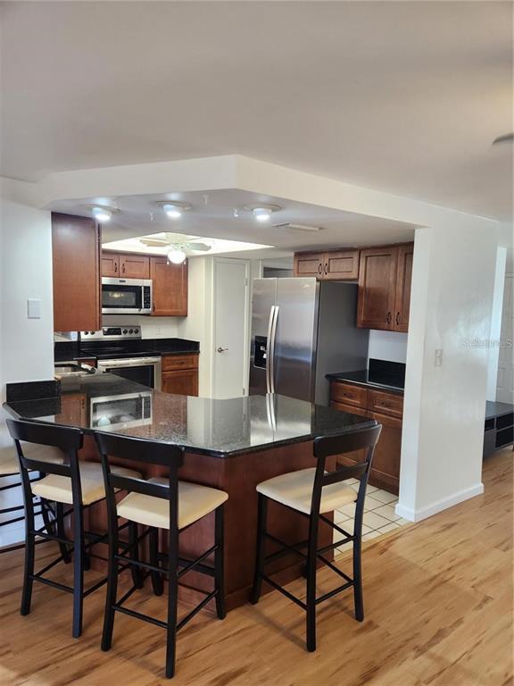 7021 Sonata Drive Port Richey, FL 34668 - Photo 2 of 14 a dining room with furniture and wooden floor