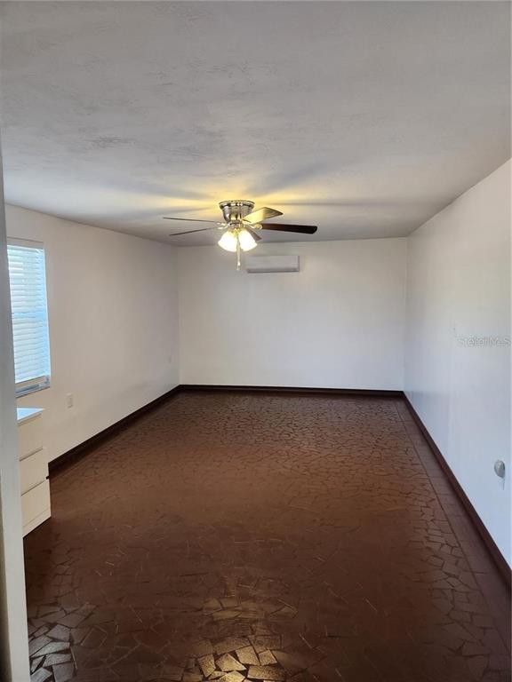 7021 Sonata Drive Port Richey, FL 34668 - Photo 8 of 14 a view of a room with a ceiling fan and wooden floor