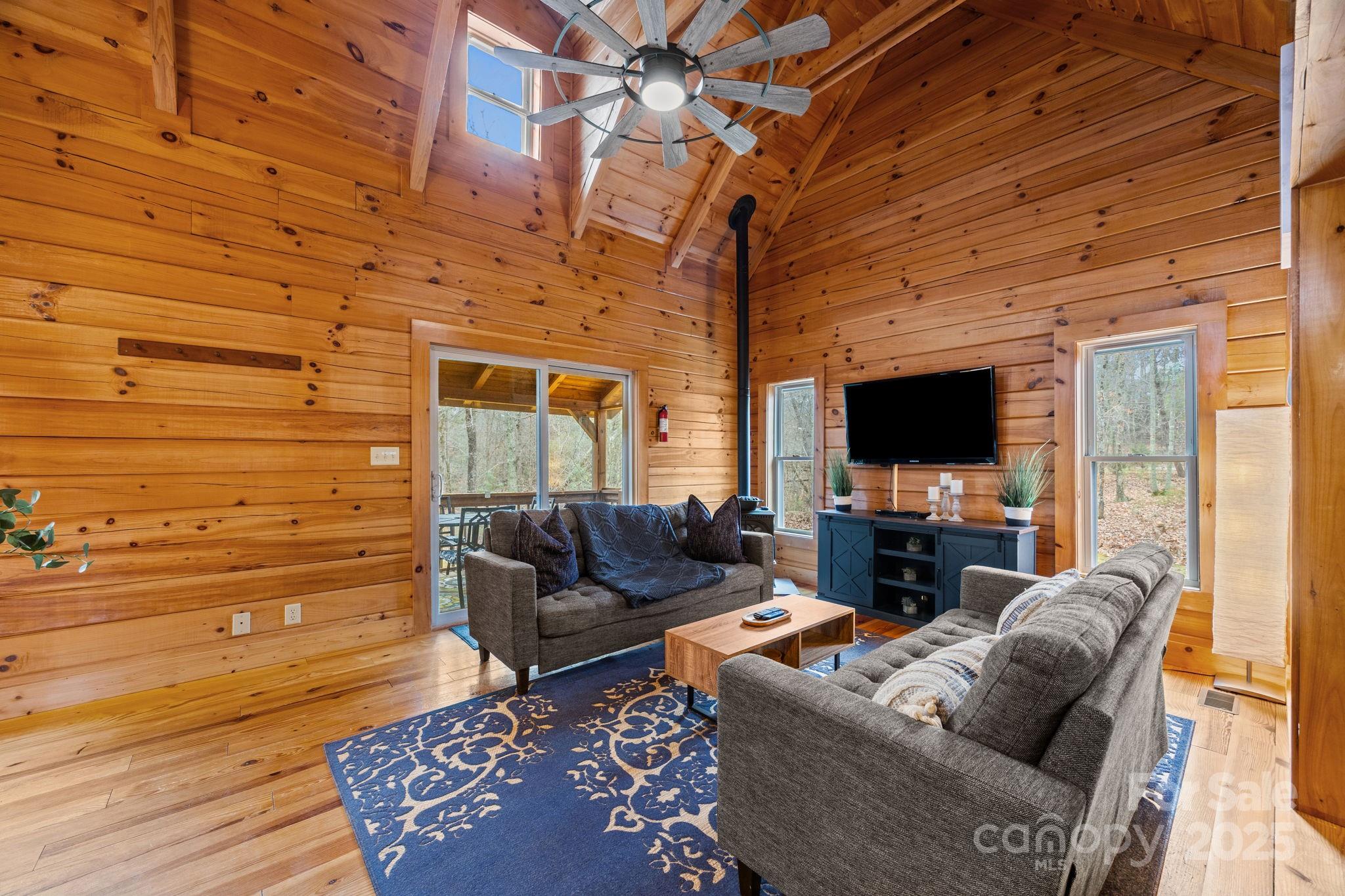 749 Buck Road Tryon, NC 28782 - Photo 13 of 45 a living room with furniture and a flat screen tv