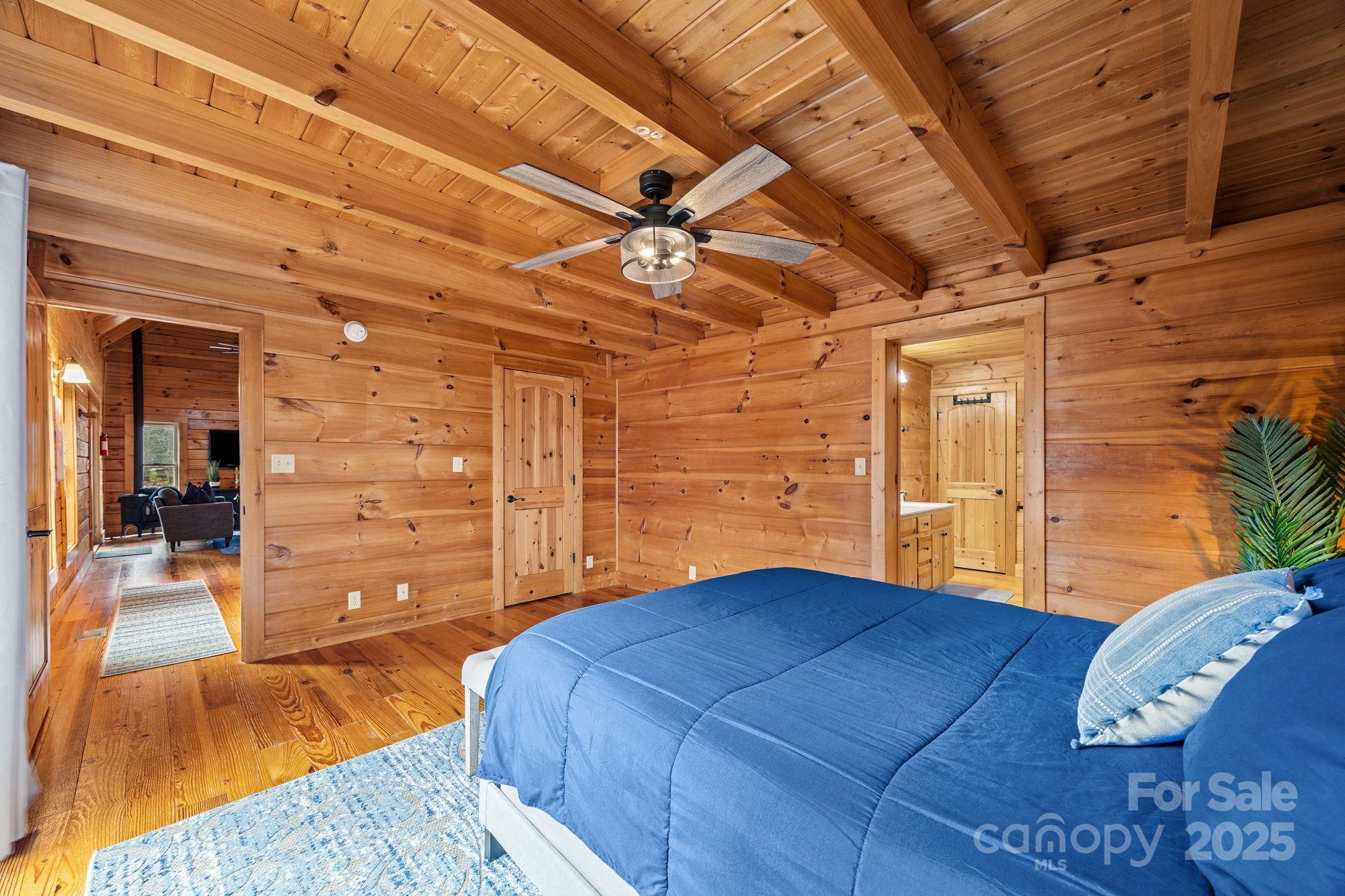 749 Buck Road Tryon, NC 28782 - Photo 19 of 45 a bedroom with a bed and a view of walk in closet