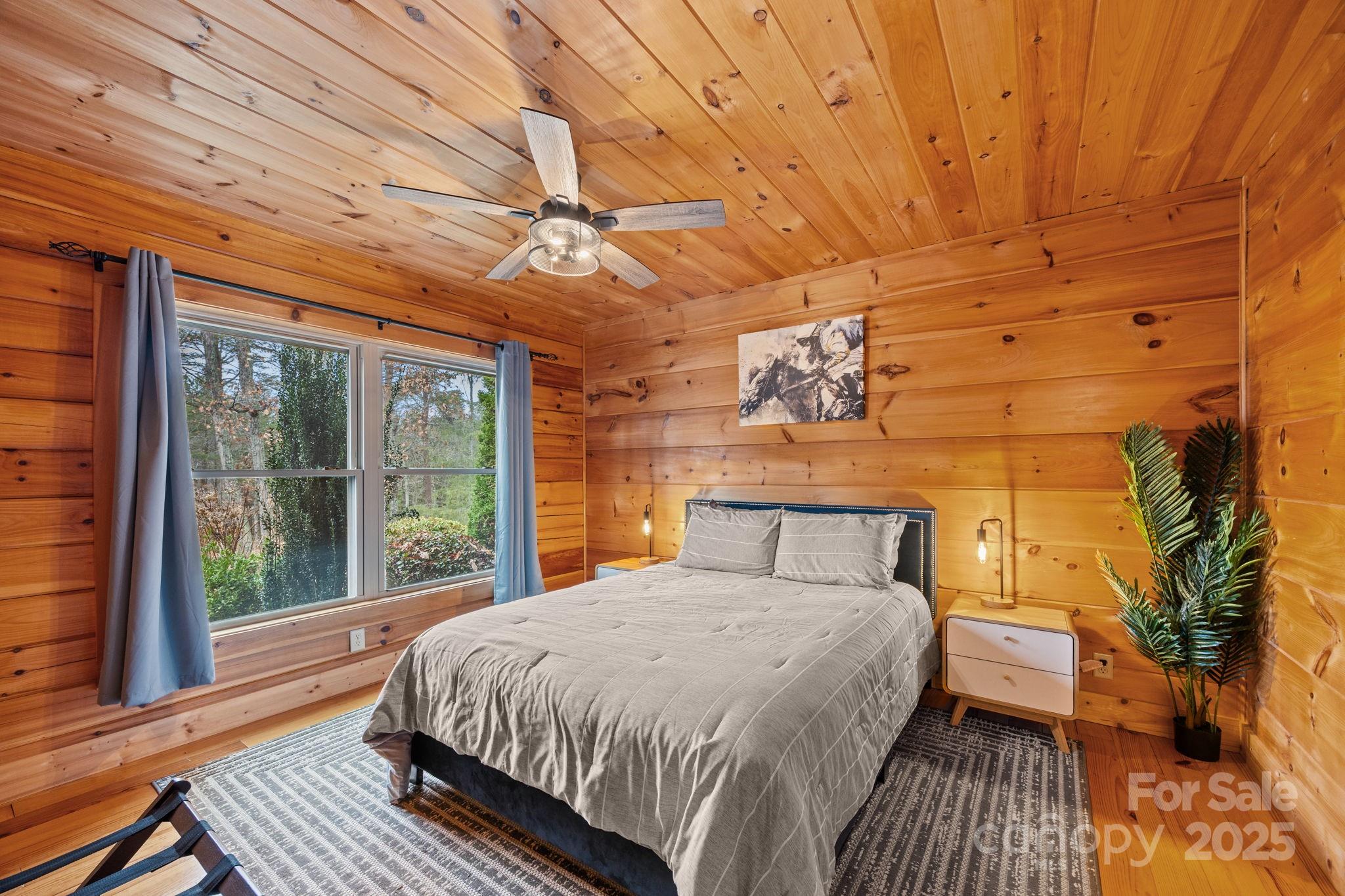 749 Buck Road Tryon, NC 28782 - Photo 23 of 45 a bedroom with a bed and wooden floor