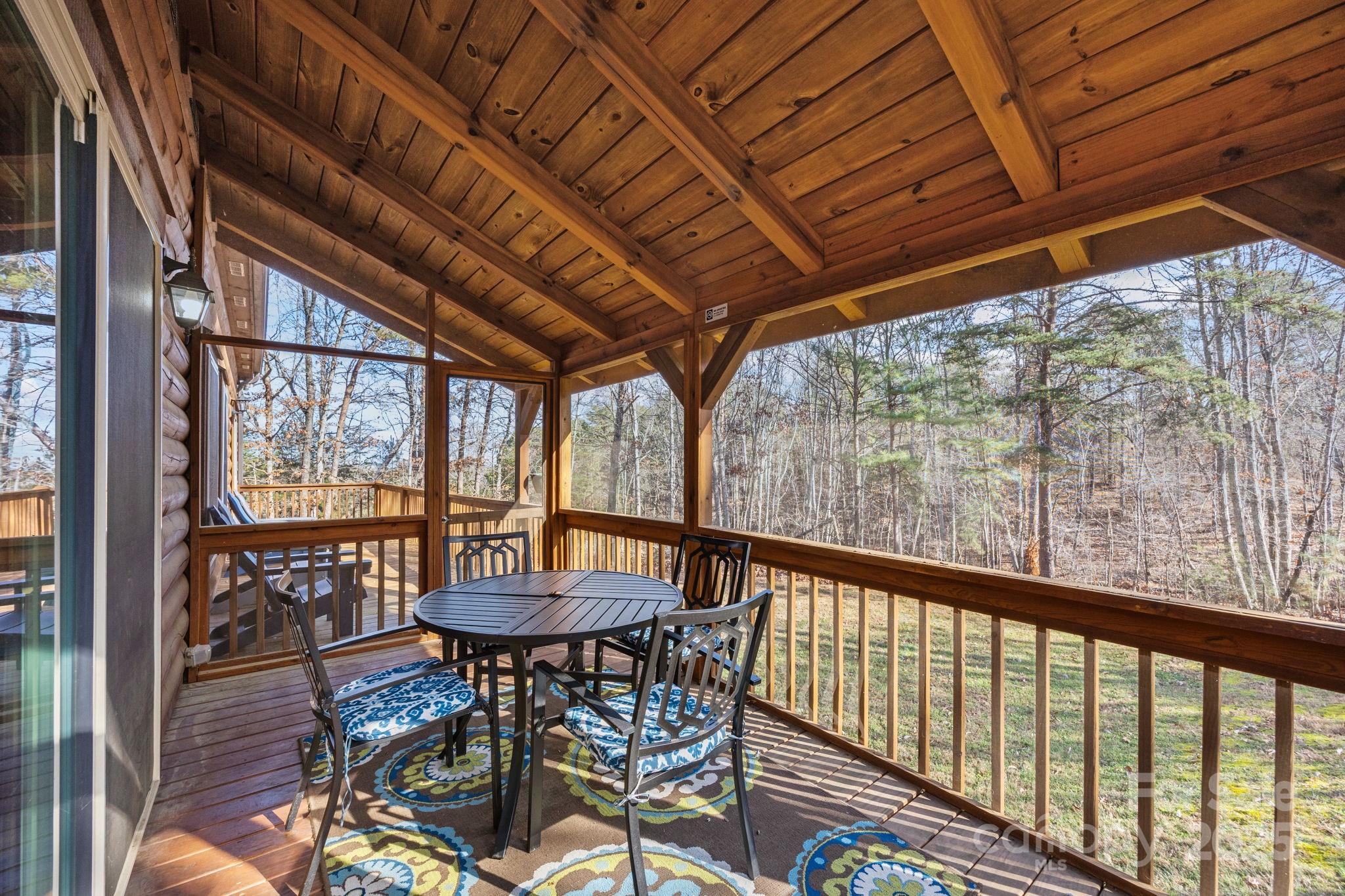 749 Buck Road Tryon, NC 28782 - Photo 33 of 45 a view of a patio with a table chairs and a large tree