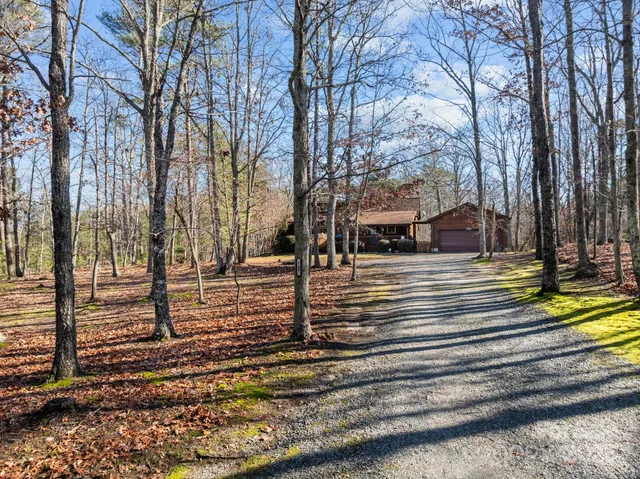 a view of a house with a yard chairs and floor to ceiling window