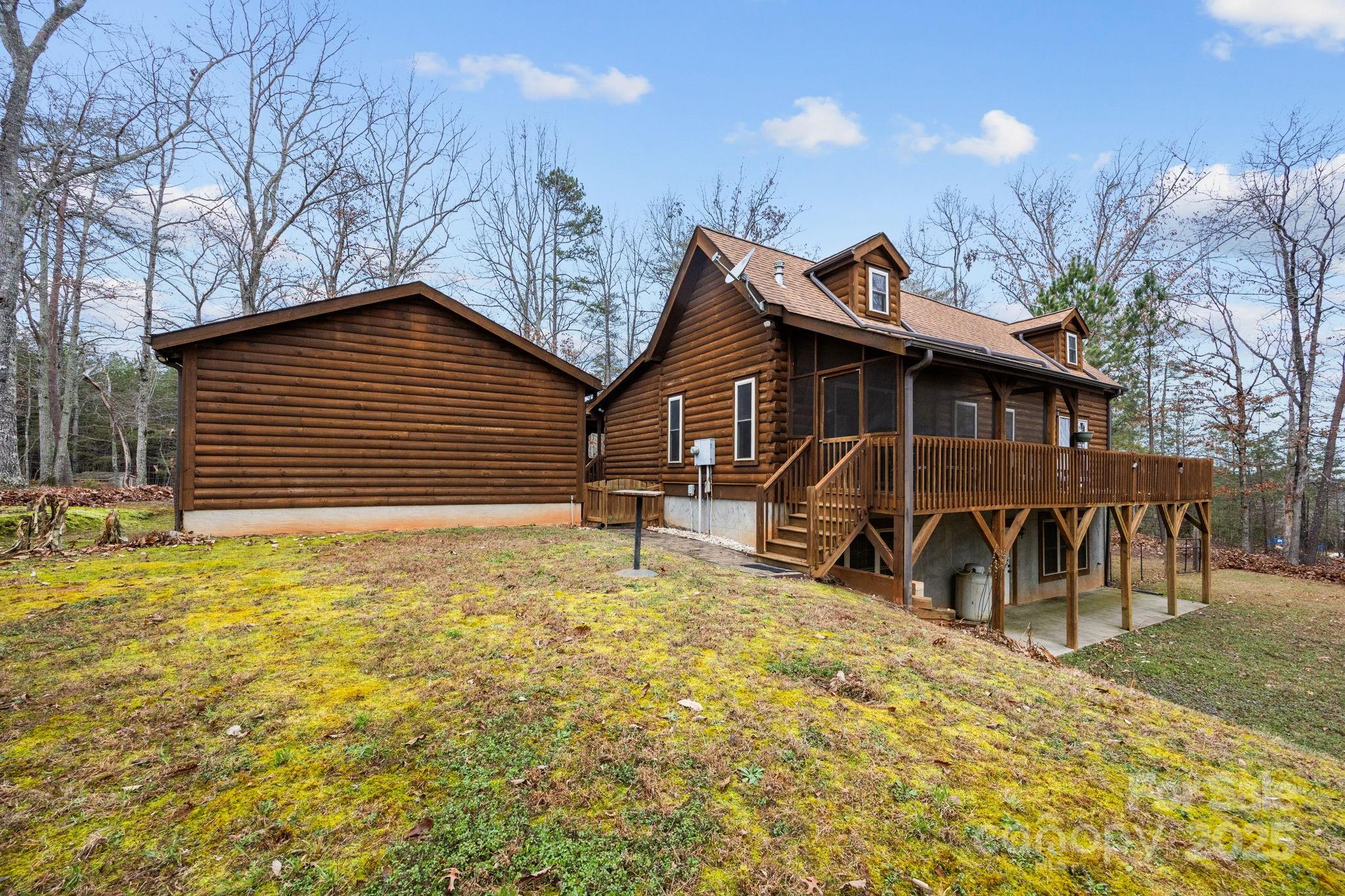 749 Buck Road Tryon, NC 28782 - Photo 5 of 45 a view of a house with a yard chairs and floor to ceiling window