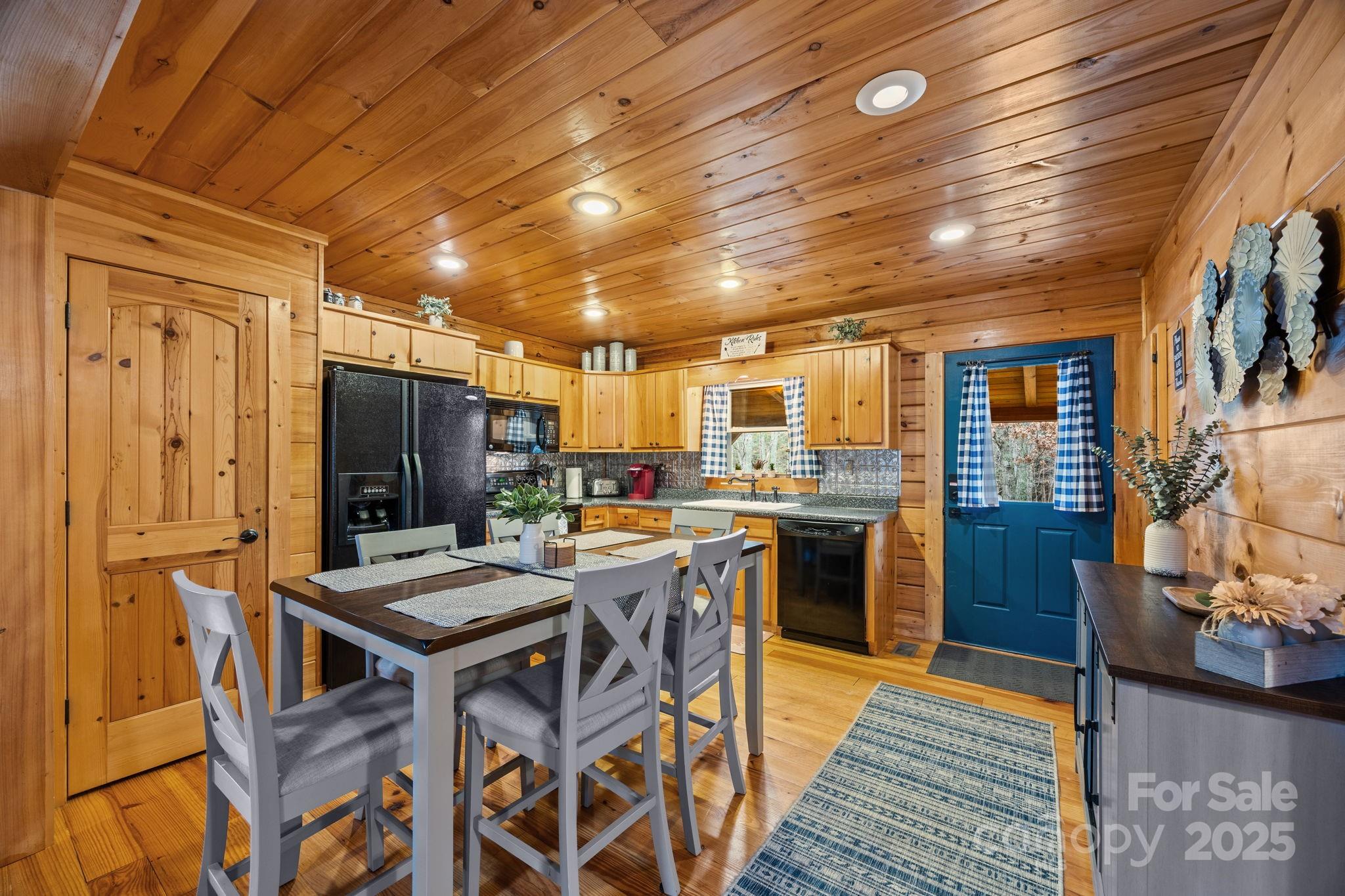 749 Buck Road Tryon, NC 28782 - Photo 8 of 45 a kitchen with a table chairs refrigerator and stove