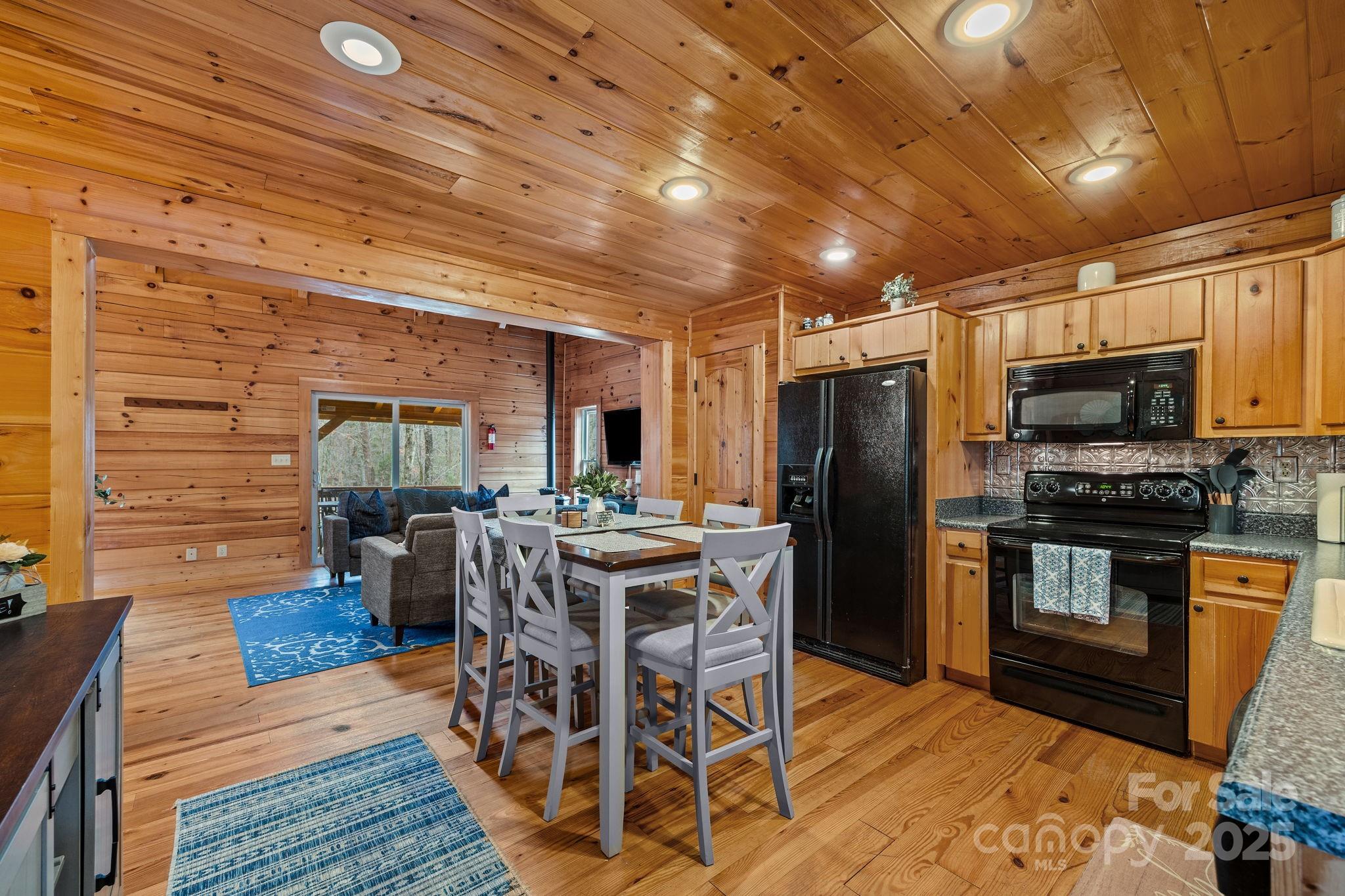 749 Buck Road Tryon, NC 28782 - Photo 10 of 45 a view of a dining room with furniture window and wooden floor