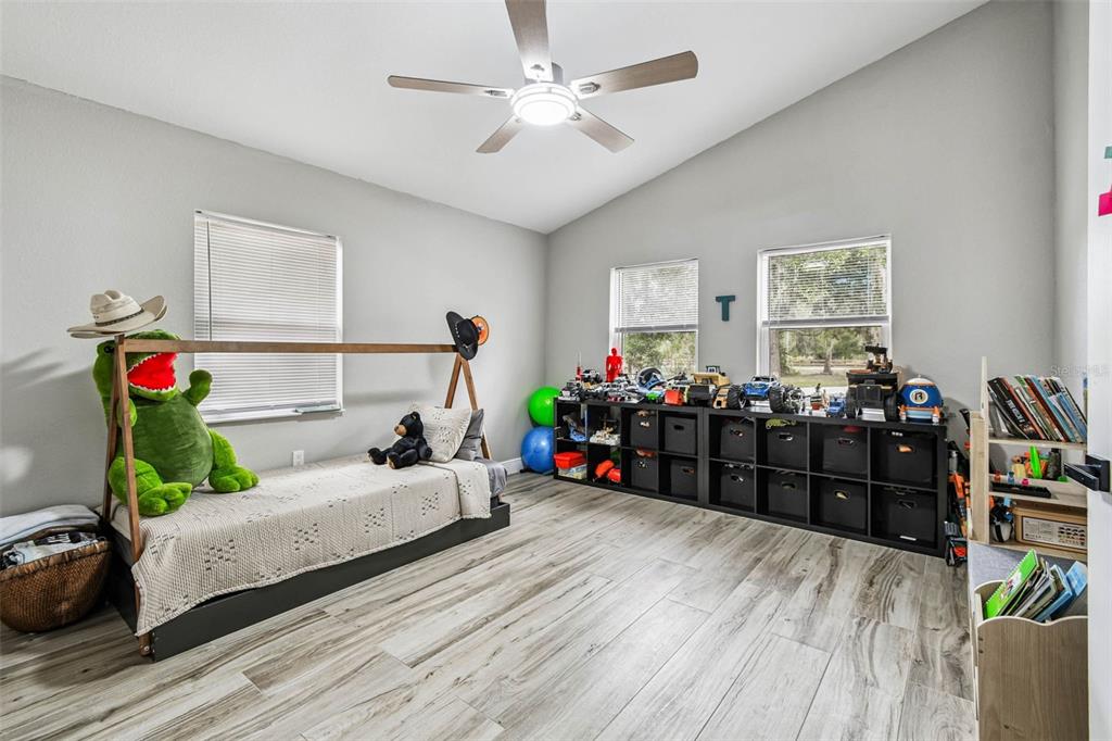 748 McClellan Road Frostproof, FL 33843 - Photo 11 of 31 a living room with furniture and wooden floor