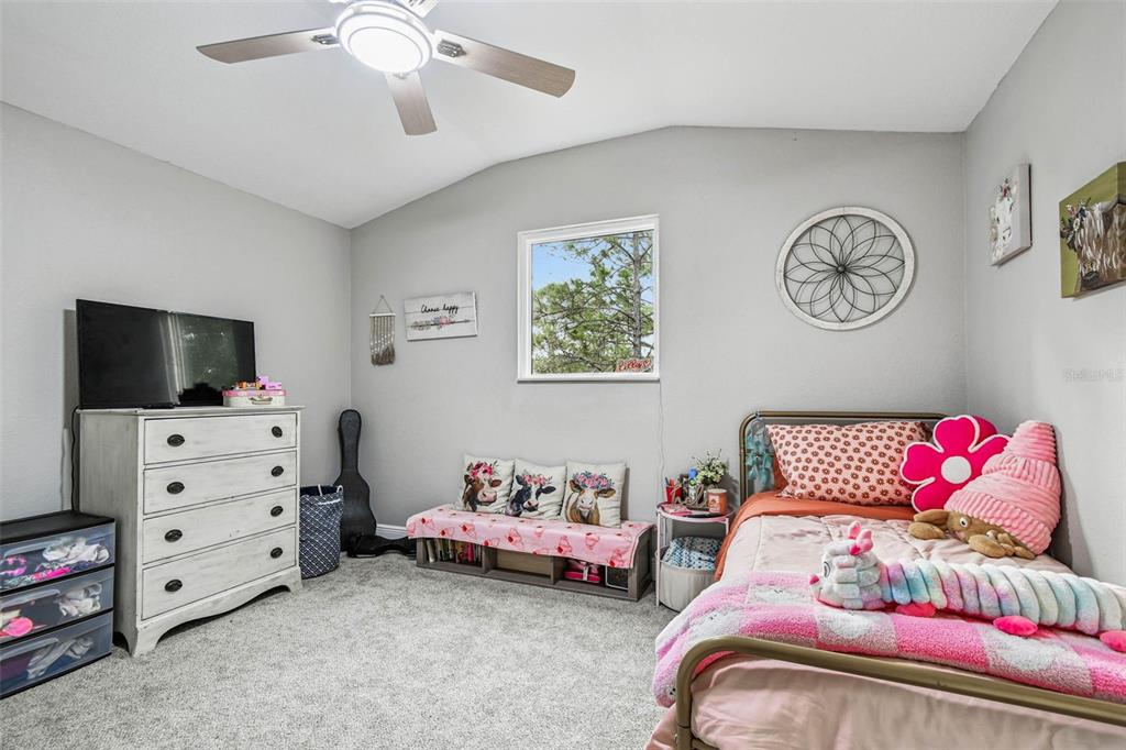 748 McClellan Road Frostproof, FL 33843 - Photo 15 of 31 a bedroom with furniture and a flat screen tv
