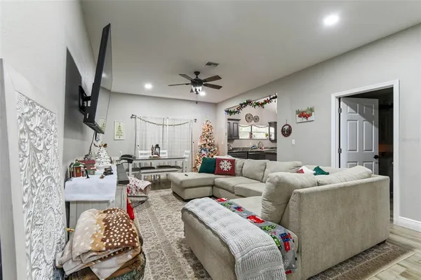 a living room with furniture and a chandelier
