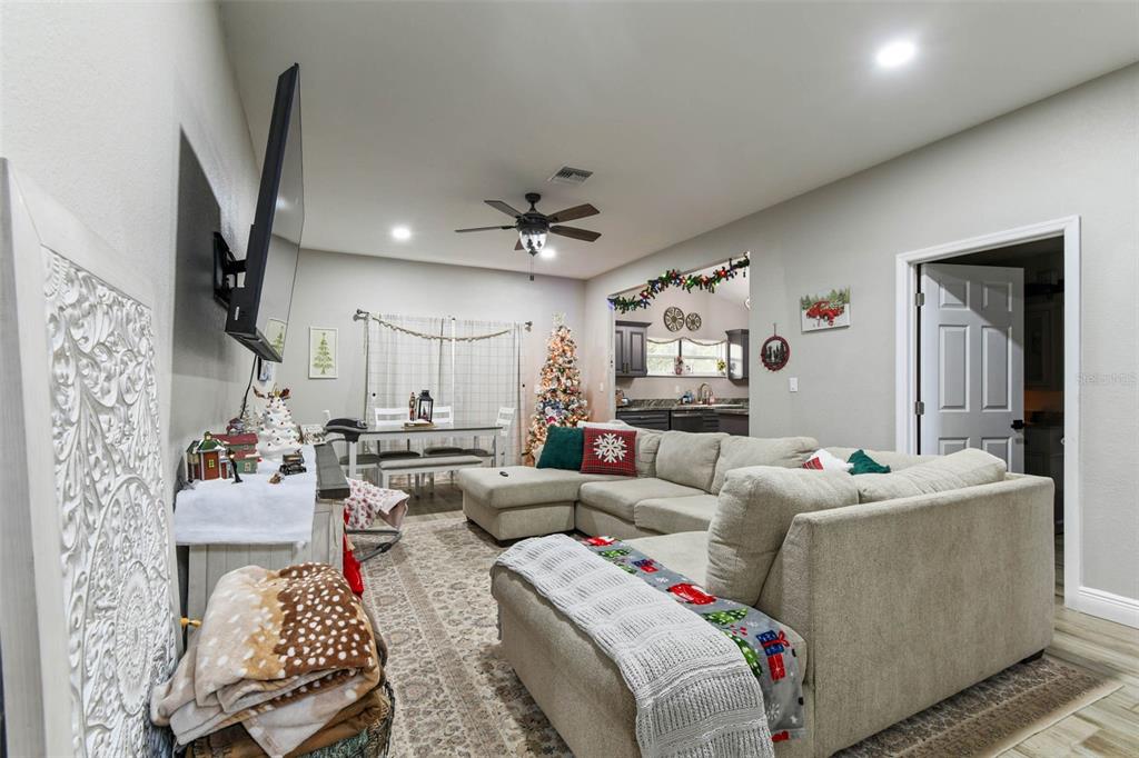 748 McClellan Road Frostproof, FL 33843 - Photo 3 of 31 a living room with furniture and a chandelier