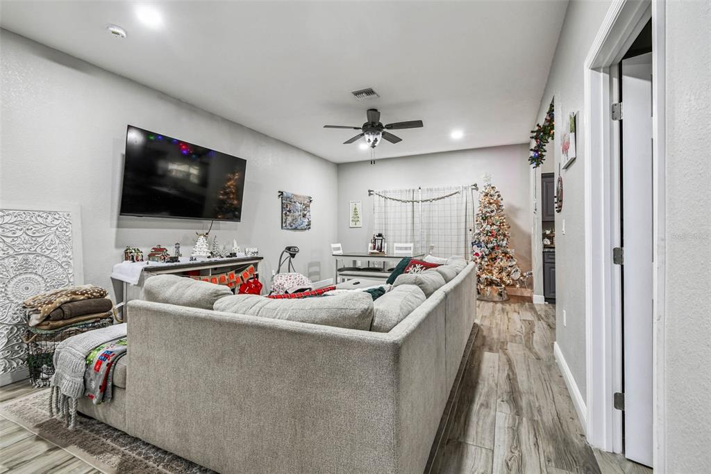 748 McClellan Road Frostproof, FL 33843 - Photo 4 of 31 a view of a livingroom with workspace and a flat screen tv