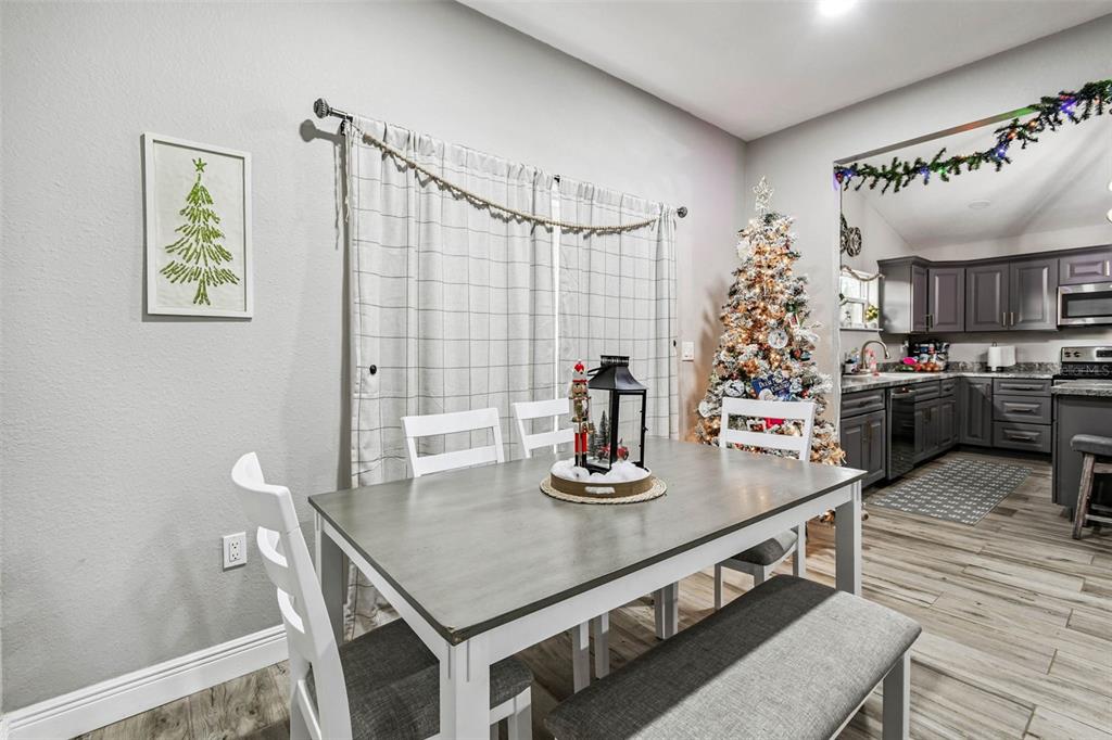 748 McClellan Road Frostproof, FL 33843 - Photo 5 of 31 a kitchen with kitchen island stainless steel appliances a table and chairs in it
