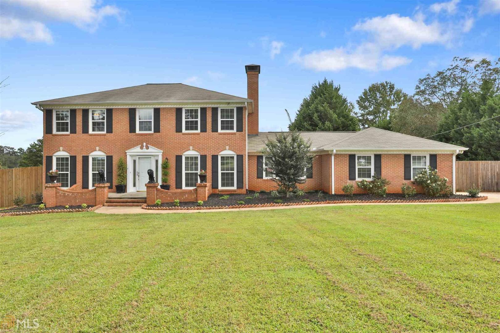 2735 South Walkers Mill Road Griffin, GA 30224 - Photo 1 of 1 a front view of a house with a garden
