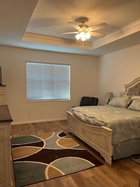 7882 Southwest 85th Loop Ocala, FL 34476 - Photo 15 of 27 a bedroom with a bed and a chandelier