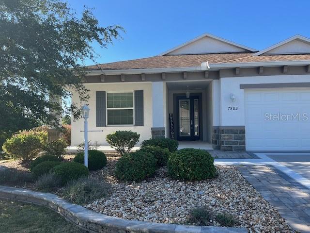 7882 Southwest 85th Loop Ocala, FL 34476 - Photo 2 of 27 a front view of a house with garden