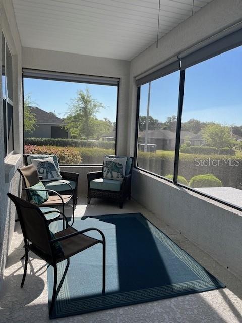 7882 Southwest 85th Loop Ocala, FL 34476 - Photo 21 of 27 a living room with a large window and a table