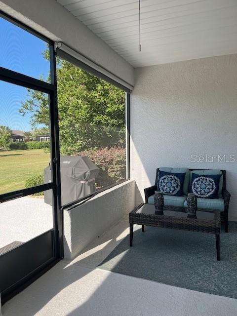 7882 Southwest 85th Loop Ocala, FL 34476 - Photo 22 of 27 a living room with furniture and a floor to ceiling window