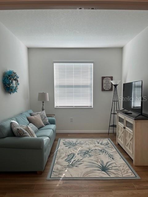 7882 Southwest 85th Loop Ocala, FL 34476 - Photo 5 of 27 a living room with furniture and a flat screen tv