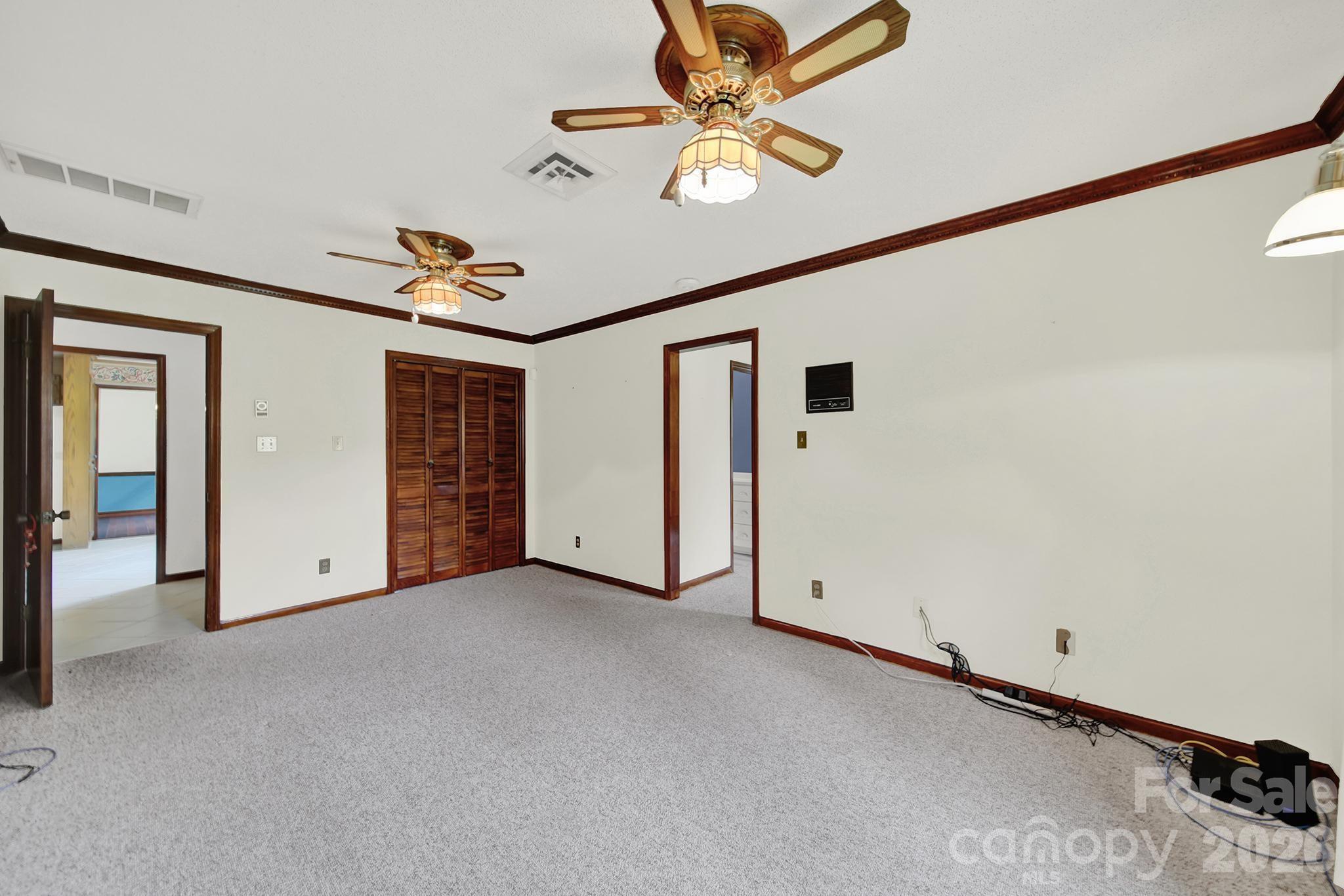 5913 Tom Query Road Charlotte, NC 28213 - Photo 22 of 47 an empty room with closet and fan
