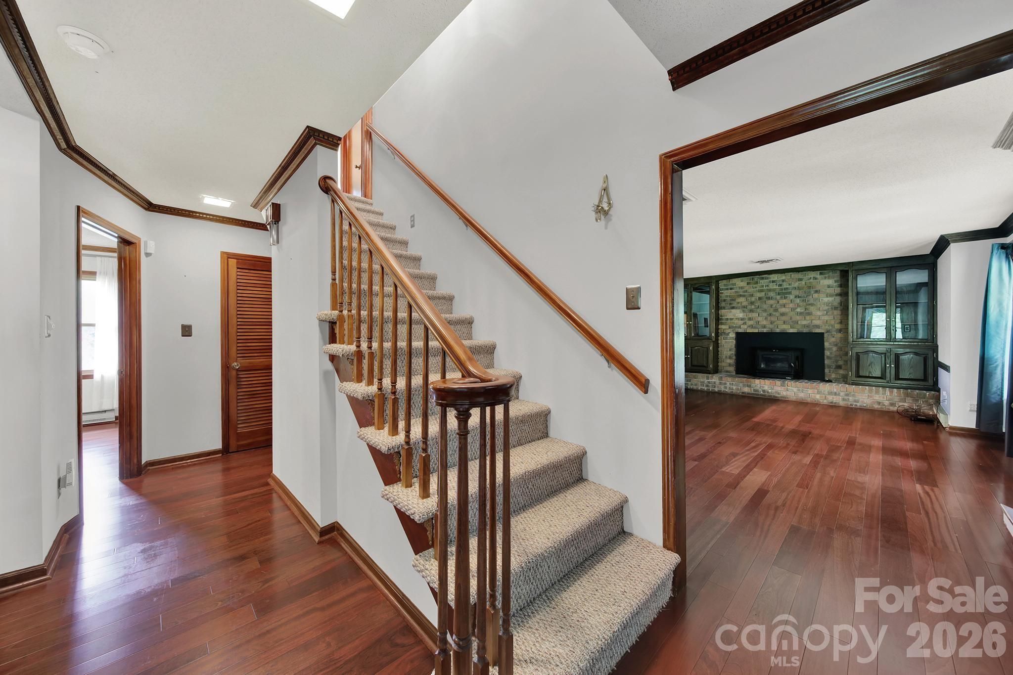 5913 Tom Query Road Charlotte, NC 28213 - Photo 3 of 47 a view of staircase with wooden floor and a large window