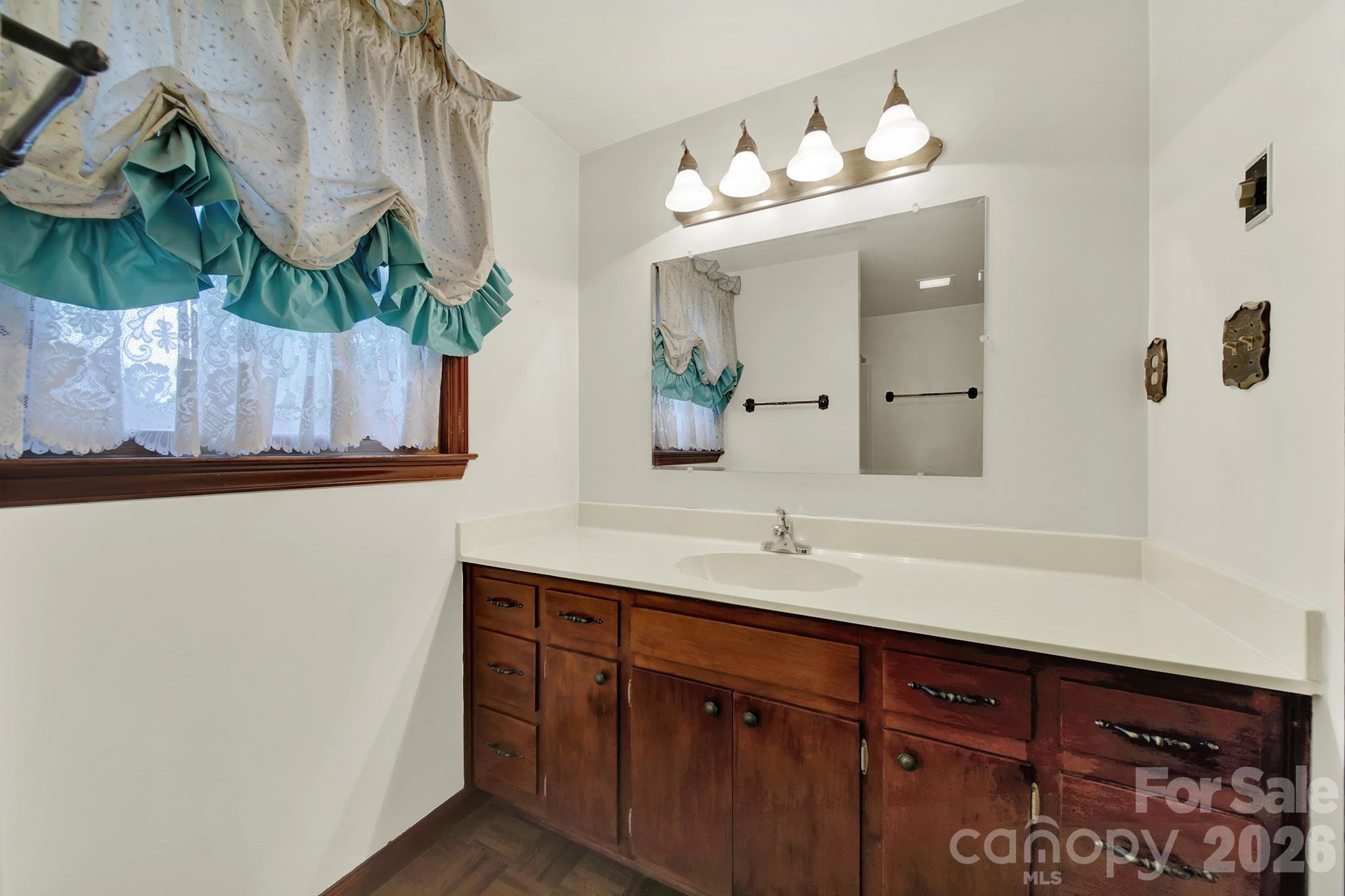 5913 Tom Query Road Charlotte, NC 28213 - Photo 31 of 47 a bathroom with a sink and a mirror