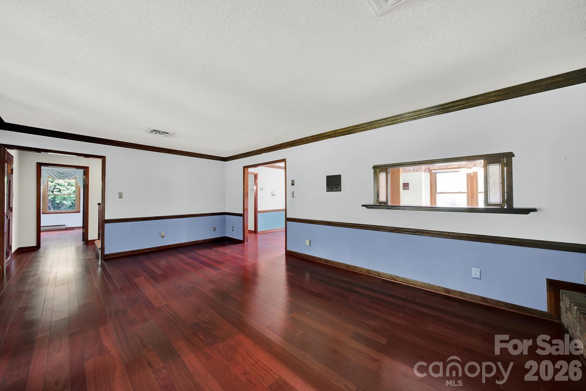 5913 Tom Query Road Charlotte, NC 28213 - Photo 7 of 47 a view of an empty room with wooden floor and a window