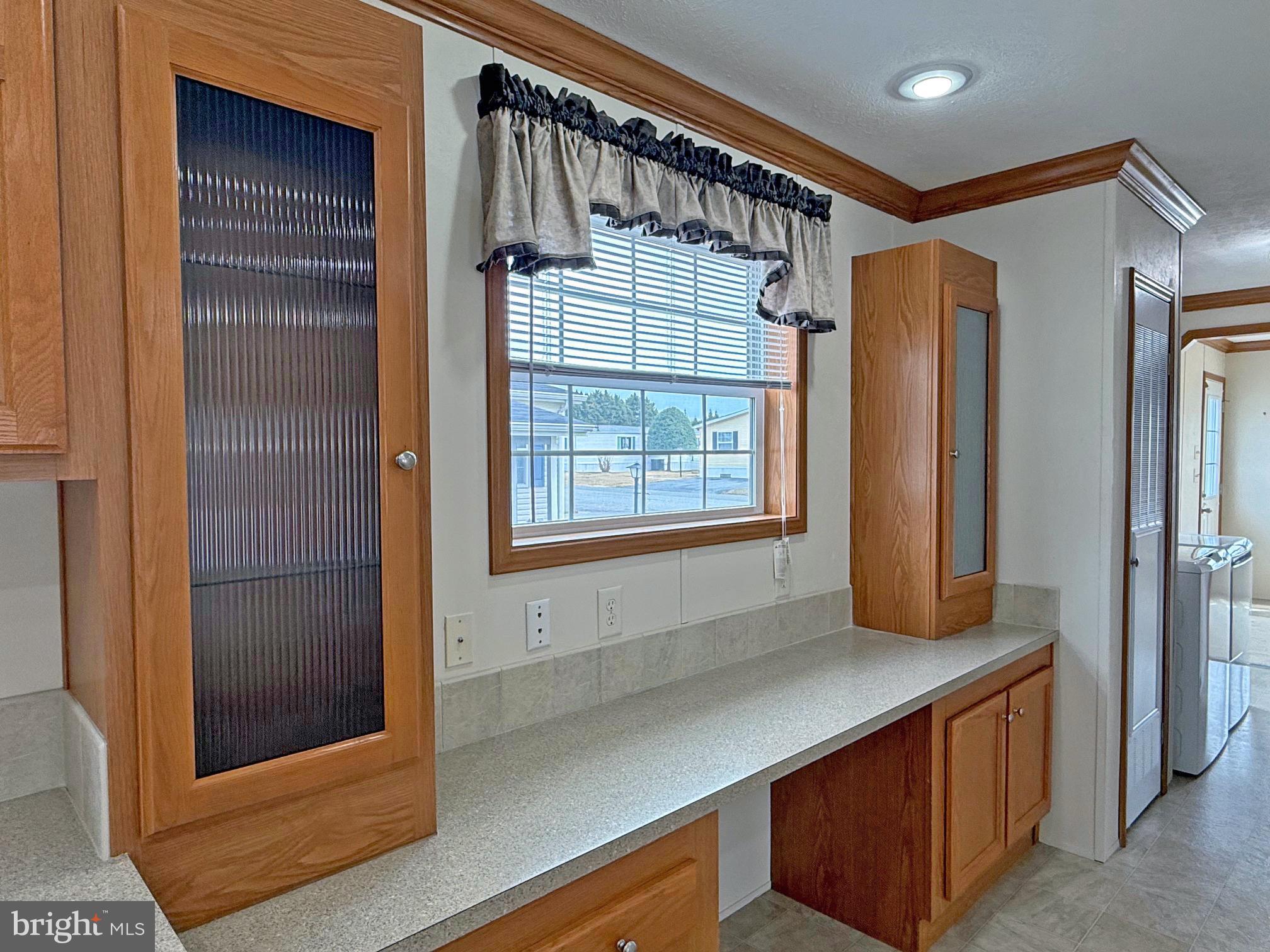 25 Baybreeze Road, Unit C29 Rehoboth Beach, DE 19971 - Photo 11 of 36 a hallway with a large window and chandelier
