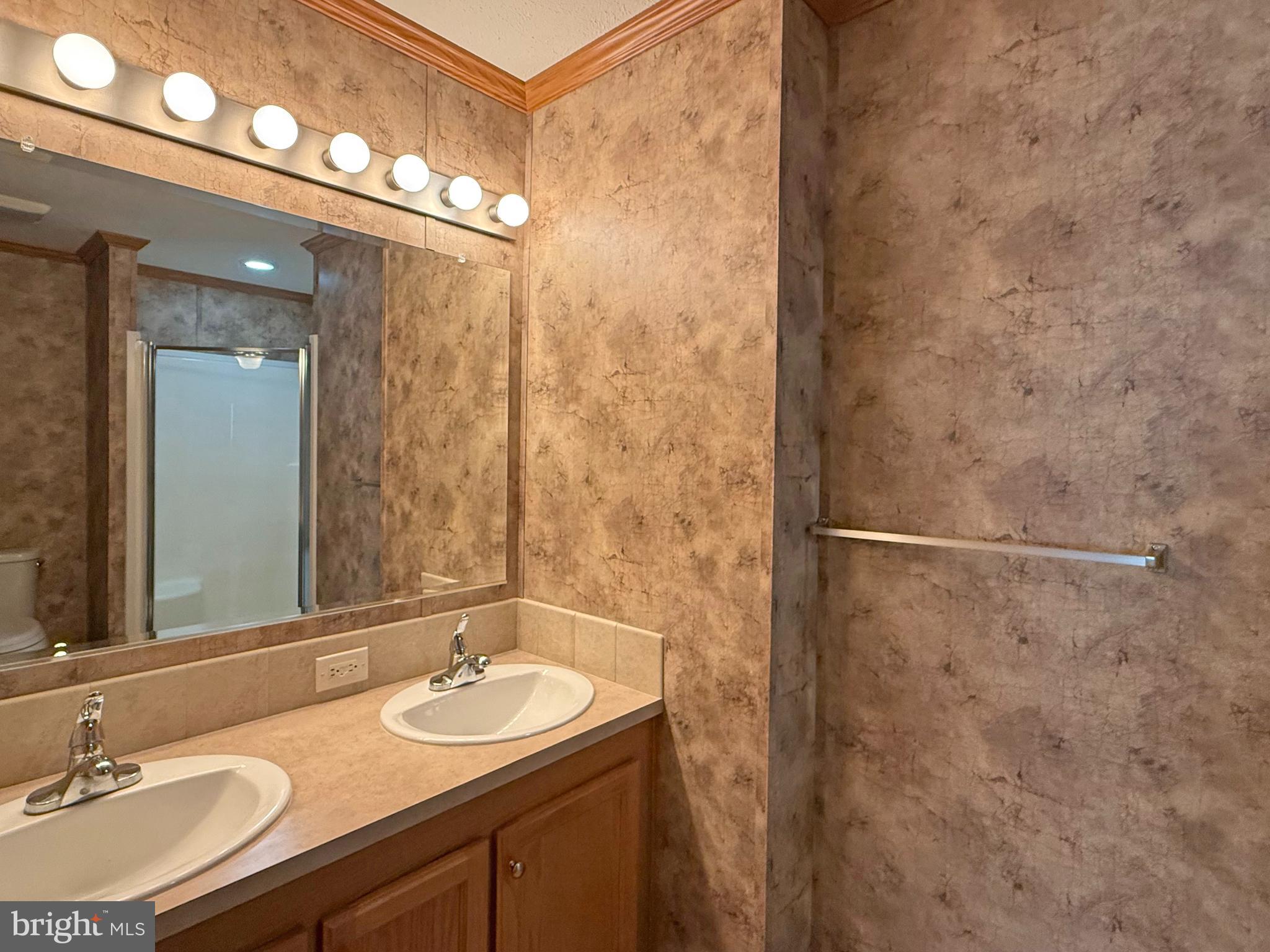 25 Baybreeze Road, Unit C29 Rehoboth Beach, DE 19971 - Photo 16 of 36 a bathroom with a sink and a mirror