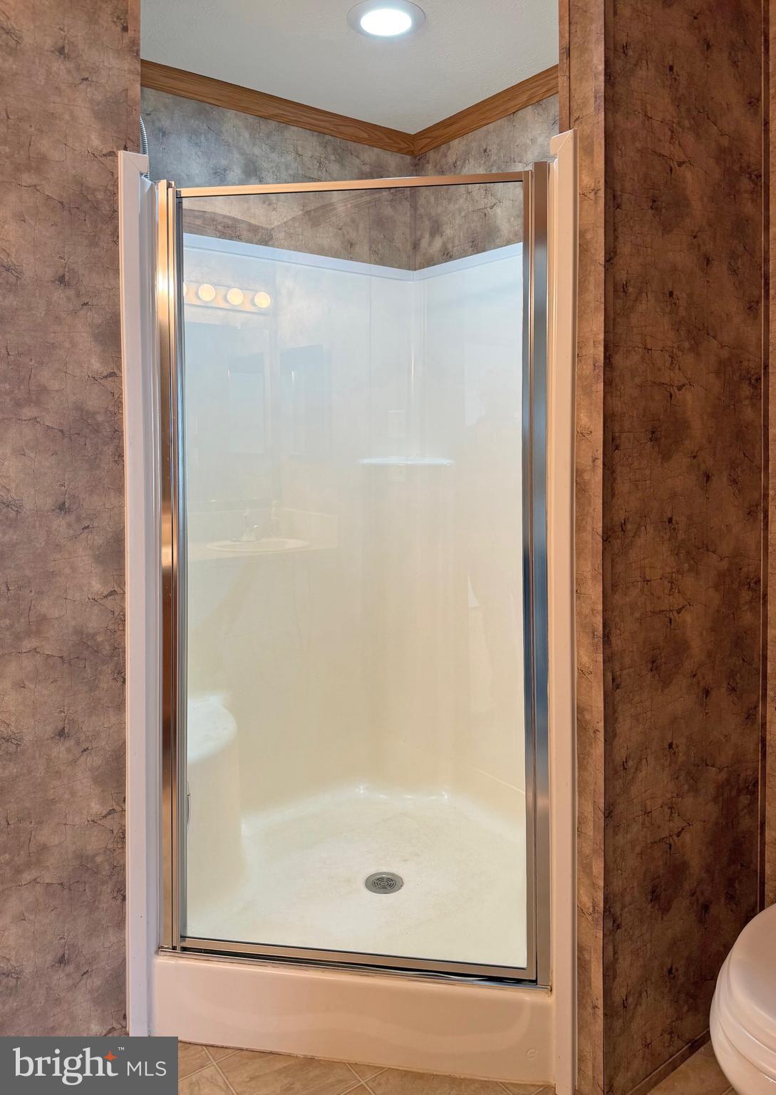 25 Baybreeze Road, Unit C29 Rehoboth Beach, DE 19971 - Photo 17 of 36 a bathroom with a glass shower door