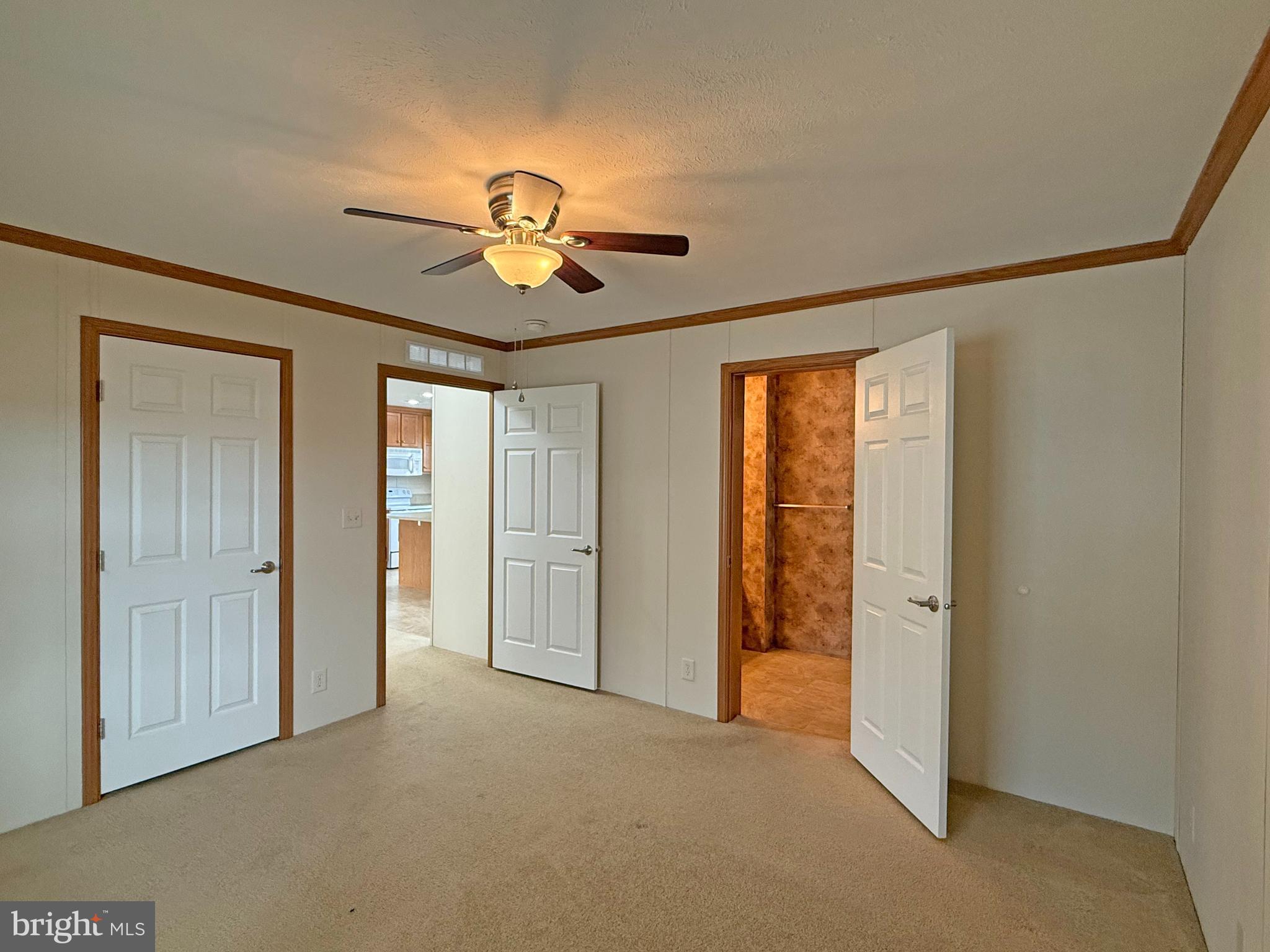 25 Baybreeze Road, Unit C29 Rehoboth Beach, DE 19971 - Photo 18 of 36 a view of empty room with chandelier fan and window