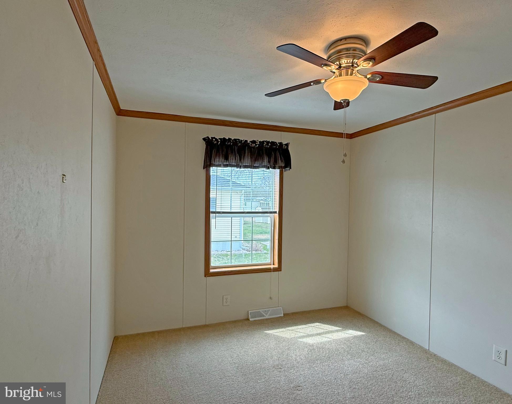 25 Baybreeze Road, Unit C29 Rehoboth Beach, DE 19971 - Photo 21 of 36 an empty room with windows and fan