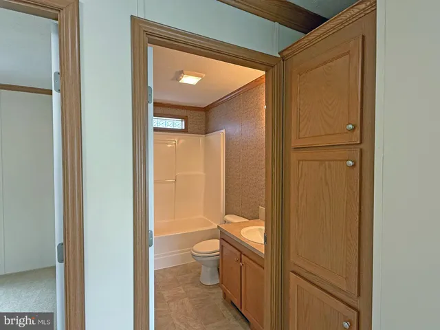a view of a chandelier fan and closet in a room