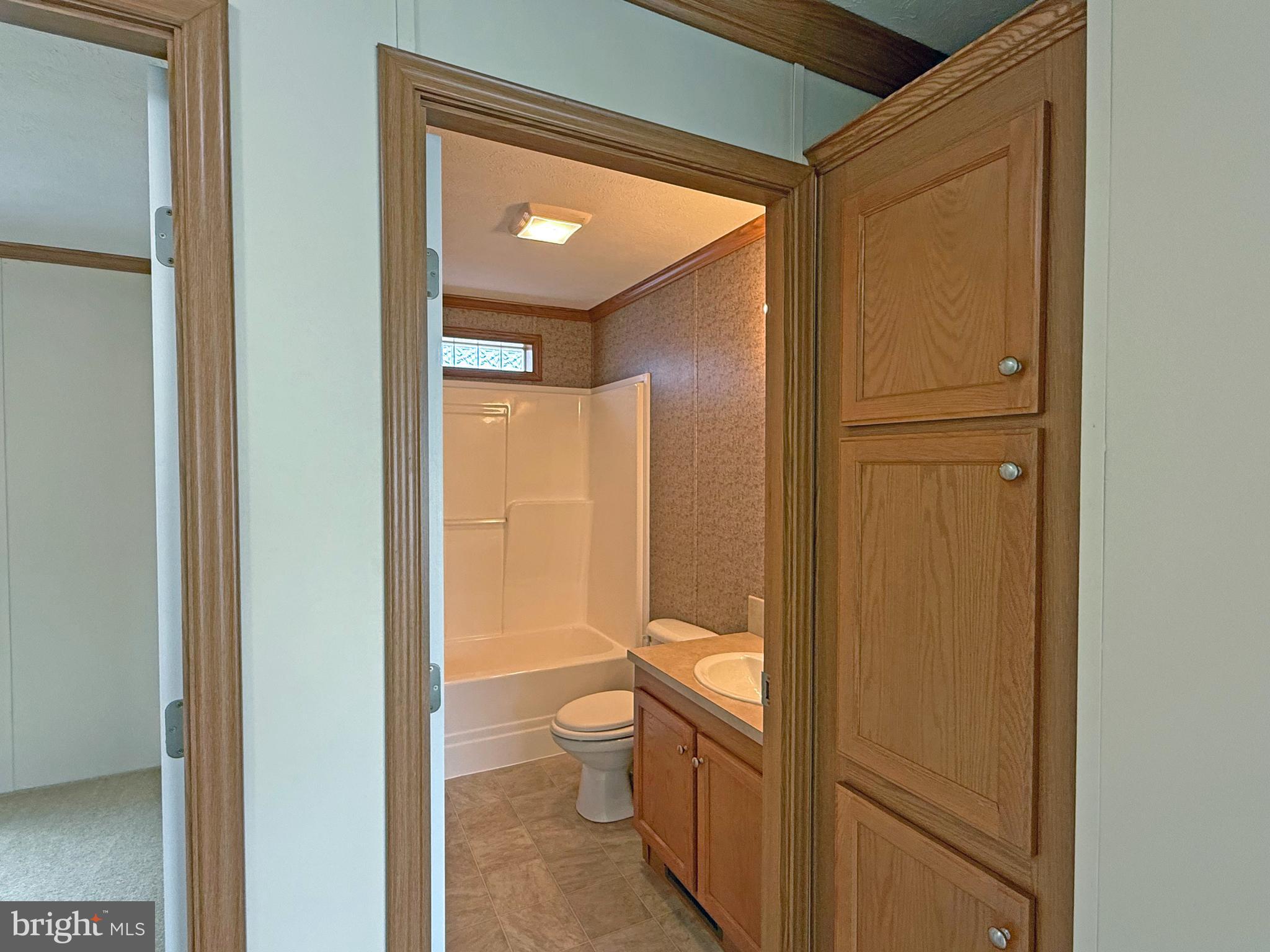 25 Baybreeze Road, Unit C29 Rehoboth Beach, DE 19971 - Photo 23 of 36 a bathroom with a granite countertop sink mirror vanity and toilet