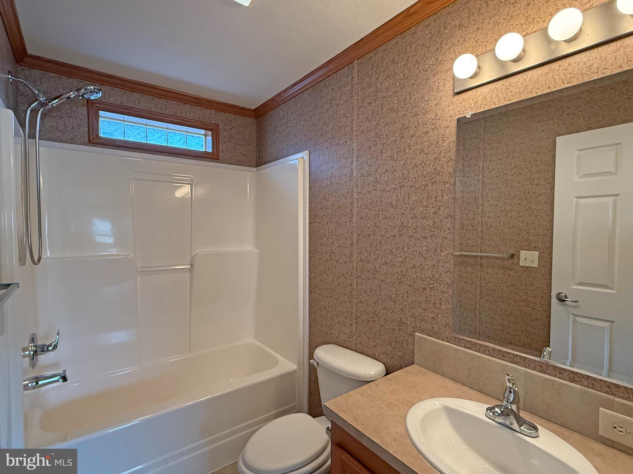 25 Baybreeze Road, Unit C29 Rehoboth Beach, DE 19971 - Photo 24 of 36 a bathroom with a sink toilet and shower