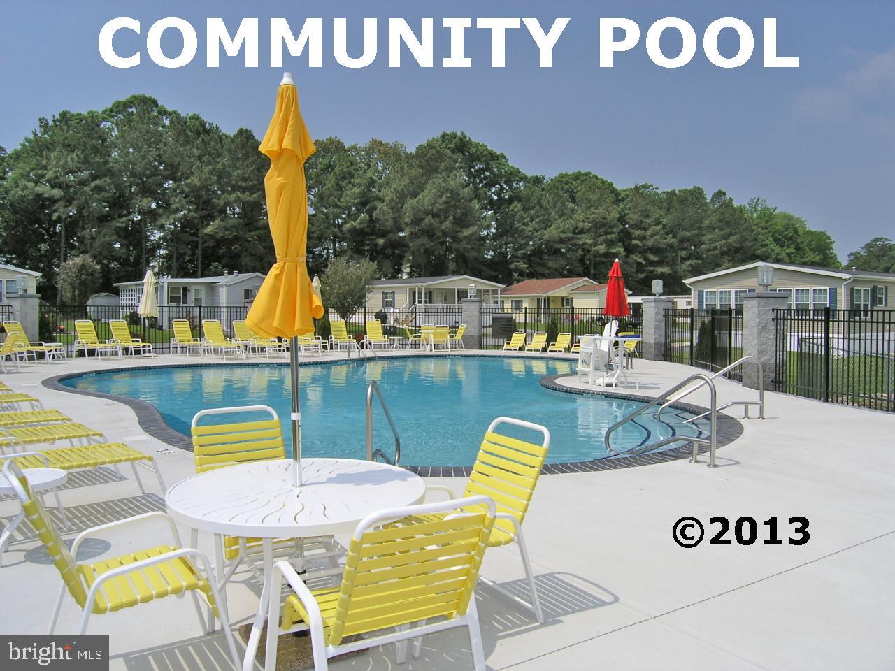 25 Baybreeze Road, Unit C29 Rehoboth Beach, DE 19971 - Photo 34 of 36 a view of a swimming pool with a lounge chair