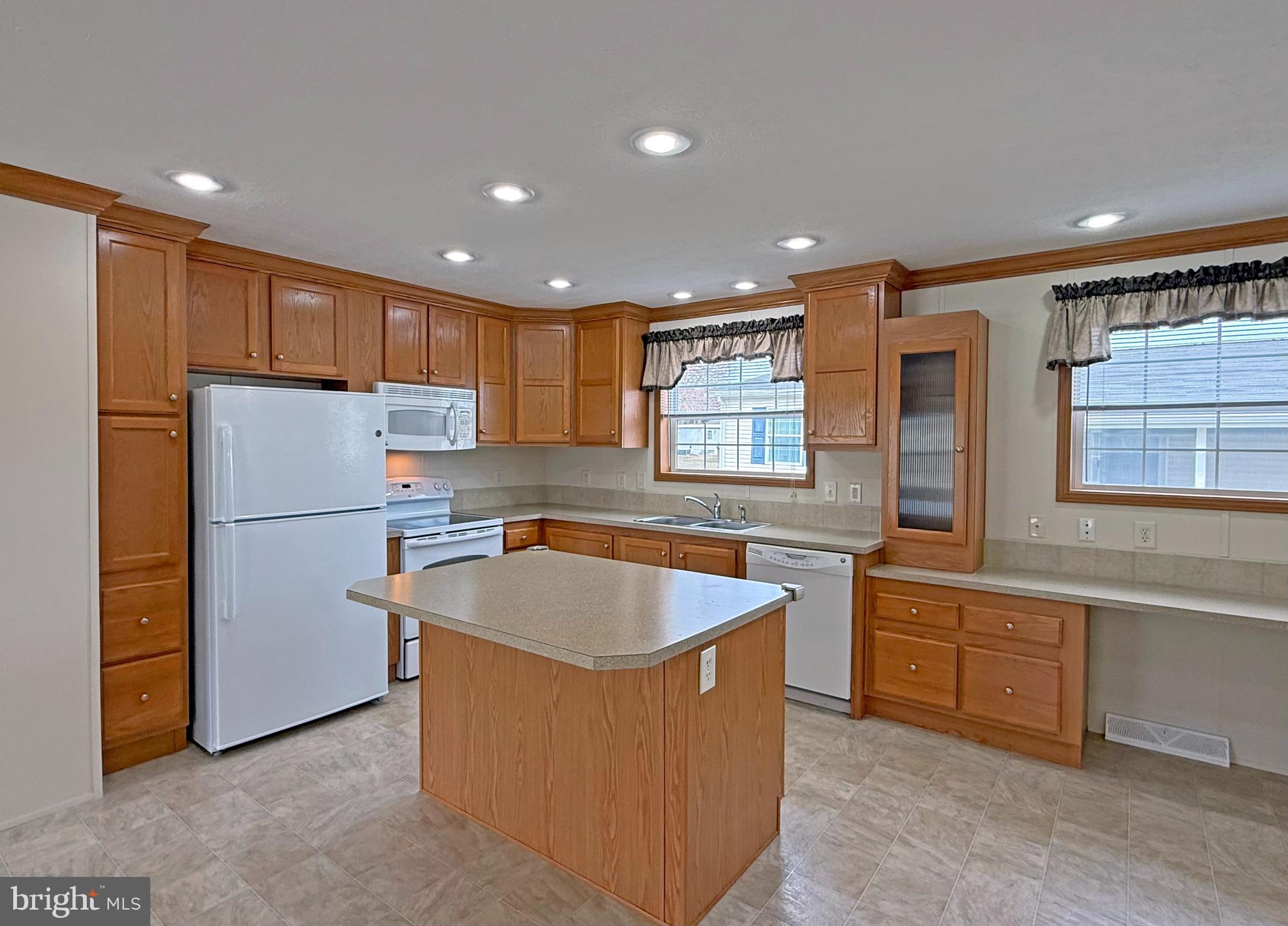 25 Baybreeze Road, Unit C29 Rehoboth Beach, DE 19971 - Photo 6 of 36 a kitchen with white cabinets and refrigerator