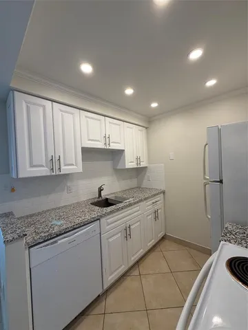 a kitchen that has a sink and a stove