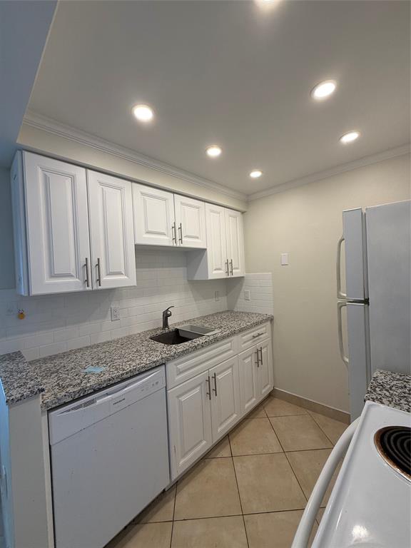 a kitchen that has a sink and a stove