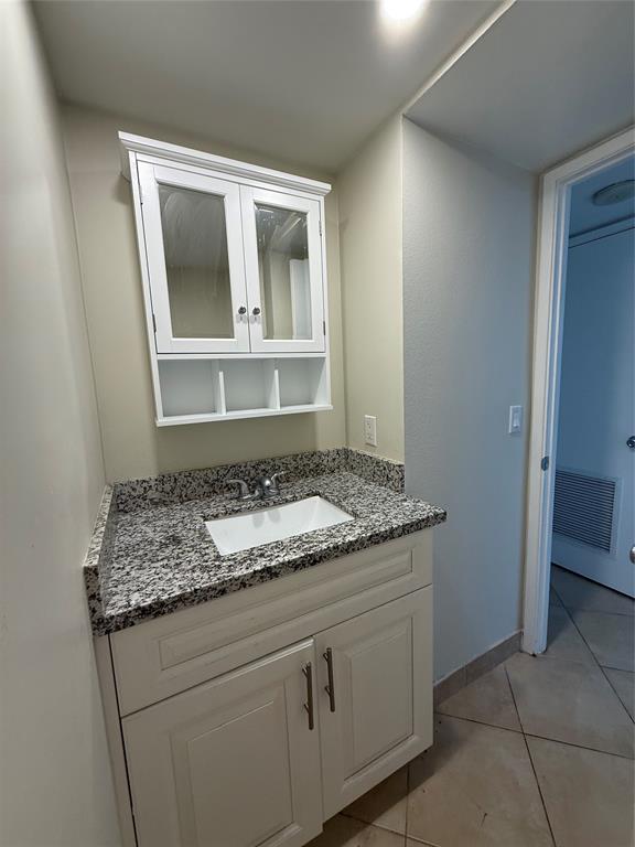 111 Briny Avenue, Unit 1805 Pompano Beach, FL 33062 - Photo 11 of 29 a bathroom with a granite countertop sink and a mirror