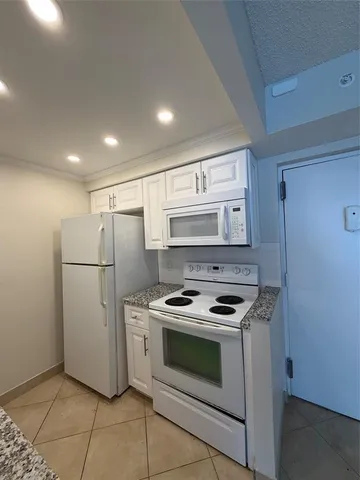 a kitchen with a stove sink and refrigerator